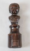 A 17th century carved oak newel post finial of a woman, on circular plinth, 11in.