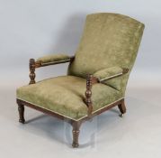 An Aesthetic movement oak armchair, in the manner of E.W. Godwin, with ring turned and fluted frame,