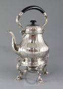 A 1930's silver tea kettle on stand with burner by Garrard & Co Ltd, of pear form, with fluted
