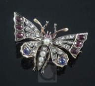 A Victorian style gold and silver, ruby, sapphire, split pearl and rose cut diamond set butterfly