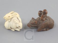 Two Japanese netsuke, 19th century, the first carved in ivory of two hares with horn or amber