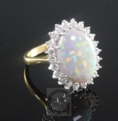 An 18ct gold, white opal and diamond oval cluster ring, the oval stone measuring approximately