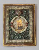 A 16th century French carved and polychrome painted wood panel, depicting a lady within a leafy