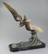 J. Bravet. An Art Deco bronze model of a seagull flying above waves, signed in the bronze, on marble