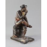 A 19th century Spanish polychrome painted terracotta figure of a seated gentleman smoking a pipe,