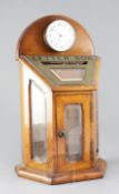 An Edwardian brass mounted golden oak and glass letter box, inset with an eight day timepiece, width