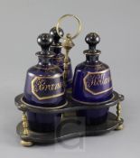 A Regency gilt decorated blue glass three bottle decanter stand, each bottle with a gilt title '