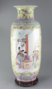 A large Chinese famille rose cylindrical vase, painted with reserves of ladies in an interior and in