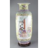 A large Chinese famille rose cylindrical vase, painted with reserves of ladies in an interior and in