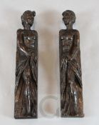 A pair of 17th century carved oak corbels, of caryatids holding drapery swags, 19.5in.