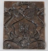 A 17th century oak panel, carved with two lions rampant above a Tudor rose, 14 x 11.5in.