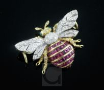 An 18ct gold, ruby, emerald and diamond set bee pendant, diameter 38mm, gross 11.7 grams.