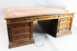 A large Victorian rosewood partner's desk, with gilt leather skiver, six frieze and twelve