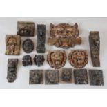 A collection of sixteen 17th / 18th century carved oak lion heads and grotesque masks,