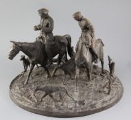 A 19th century Russian cast iron group of two huntsmen and five hounds, signed in the circular