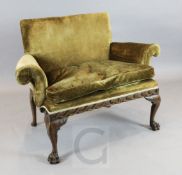 An early 18th century style walnut small settee, with olive gold velvet upholstery and all round