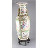 A large Chinese Canton-decorated famille rose baluster vase, 19th century, painted with figures amid