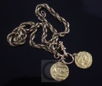 A gold ropetwist chain hung with two high carat gold Middle Eastern coins.