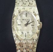 A lady's 14ct gold Rolex manual wind wrist watch, the oval dial with quarterly baton markers, on