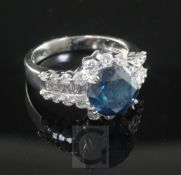 An 18ct white gold and single stone fancy colour diamond ring with round cut white diamond set