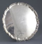 A 1920's silver shaped circular salver by Barker Brothers, Chester, 1924, with pie crust border,