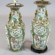 A pair of large Chinese Canton-decorated famille rose vases, each typically painted with figures