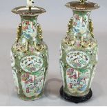 A pair of large Chinese Canton-decorated famille rose vases, each typically painted with figures