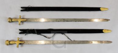 A near pair of Indian sword tulwars, late 19th century, each having gilt copper hilt with incised