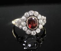 A late Victorian gold and silver, garnet and old cut diamond oval cluster ring, with ribbed