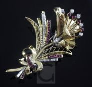A gold, ruby and diamond set floral spray brooch, set with round and baguette cut stones, apparently