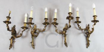 A set of four Louis XV style ormolu twin branch wall lights, of foliate scroll design, H.15in.