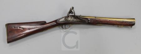 A late 18th century flintlock blunderbuss, with brass barrel, the lock signed I. Wilson, 31in.