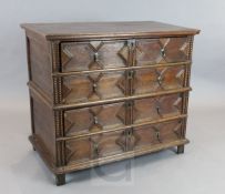 A Jacobean oak two part chest, of four geometric moulded long drawers, H.3ft 5in. D.2ft H.3ft