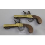 A pair of brass framed and barrelled flintlock boxlock pocket pistols, with spring bayonets, by