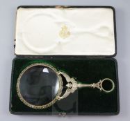 A late 19th century French parcel gilt silver magnifying glass, with angel handle, in a fitted box