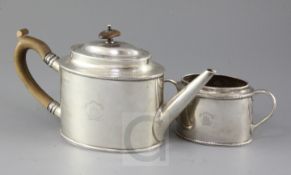 A George V silver oval teapot and matching sugar bowl engraved with latin motto 'Make For The Shore'