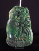 A Chinese jade pendant, carved with cranes amongst foliage, 52mm.