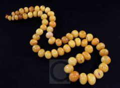 A single strand amber bead necklace, with metal clasp, gross weight 162 grams, 84cm.