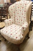 An upholstered wing armchair