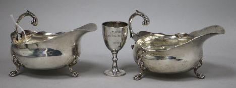 A pair of Edwardian silver sauce boats and a small trophy cup.