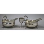 A pair of Edwardian silver sauce boats and a small trophy cup.