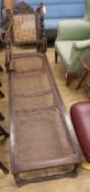 A Carolean style walnut and canework day bed, W.160cm