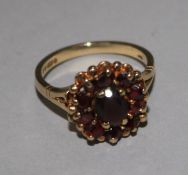 A 9ct gold and garnet set cluster ring, size M.