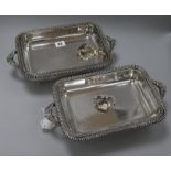 A pair of plated entree dishes, covers and stands