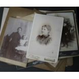 A photograph album, loose photos and a postcard album