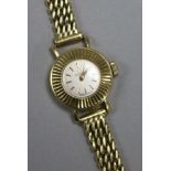 A lady's early 1950's 18ct Omega manual wind wrist watch, with baton numerals and fluted bezel, on