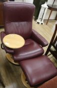 A leather reclining chair with foot stool