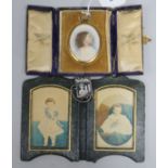 An oval miniature watercolour portrait of a young girl, a miniature silver photograph frame and a