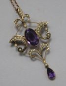 An Edwardian 9ct gold, amethyst and seed pearl set pendant/brooch, on a 9ct gold fine link chain,