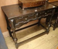 An ebonised side table, W.91cm